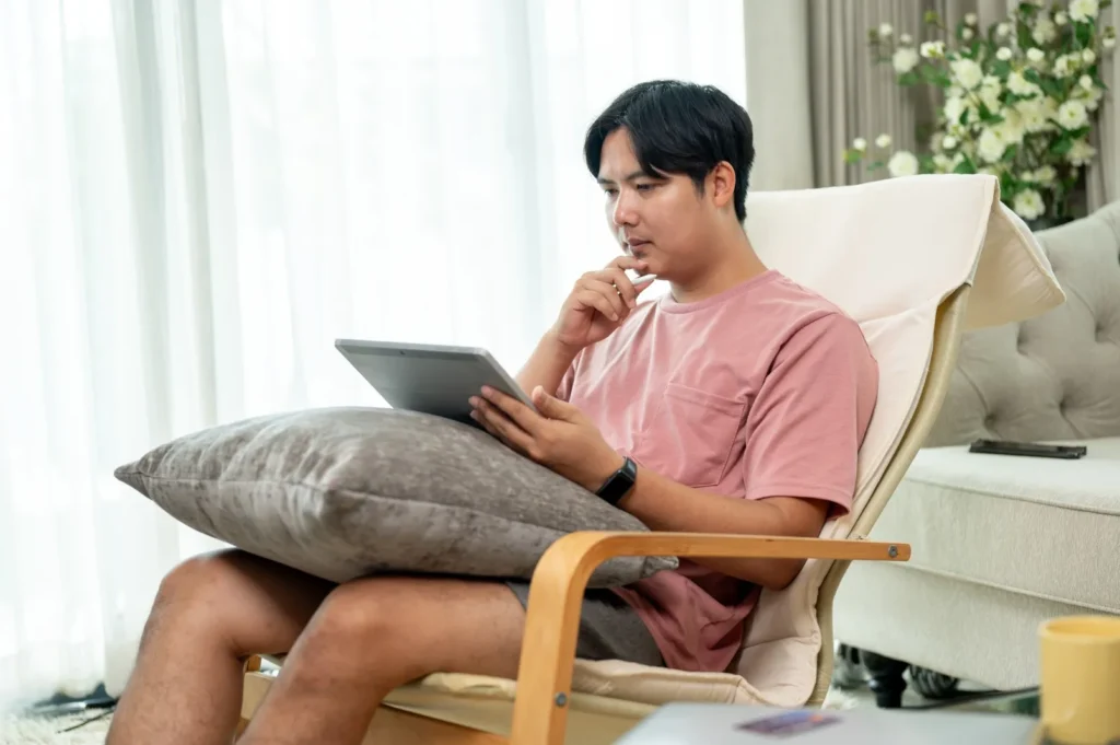 Disabled man looking at tablet at home