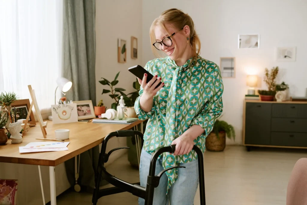 Disabled woman at home using mobile phone